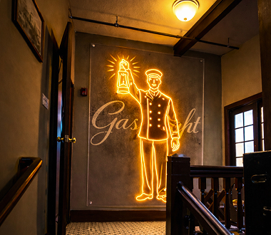Gaslight cocktail bar entrance at Porter in Ambler PA with illuminated sign